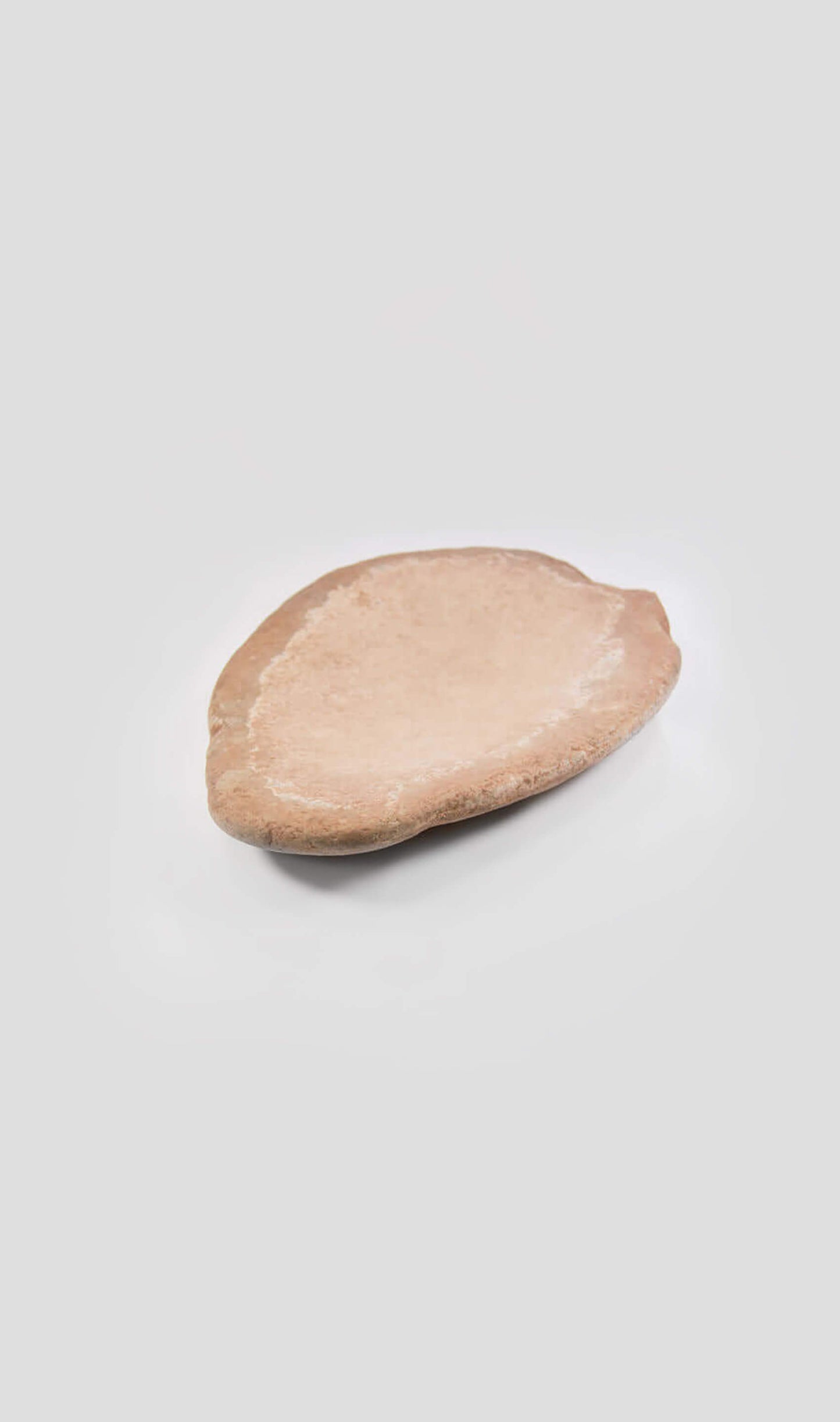 A stunning quern artefact for sale in a peach tone colour