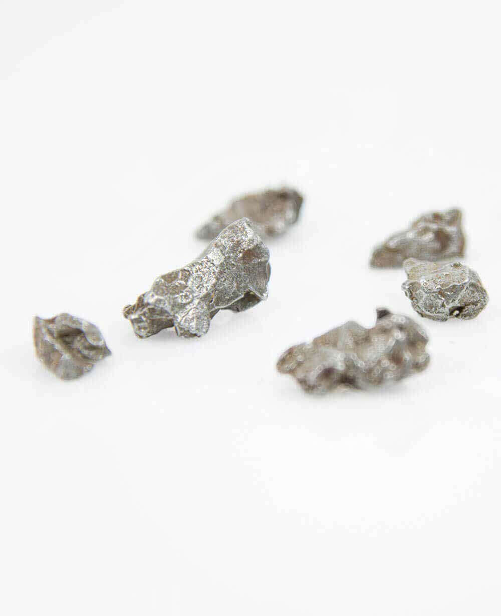 Stunning silver Argentinean meteorite fragments for sale presented in our custom designed bronze frames at THE FOSSIL STORE