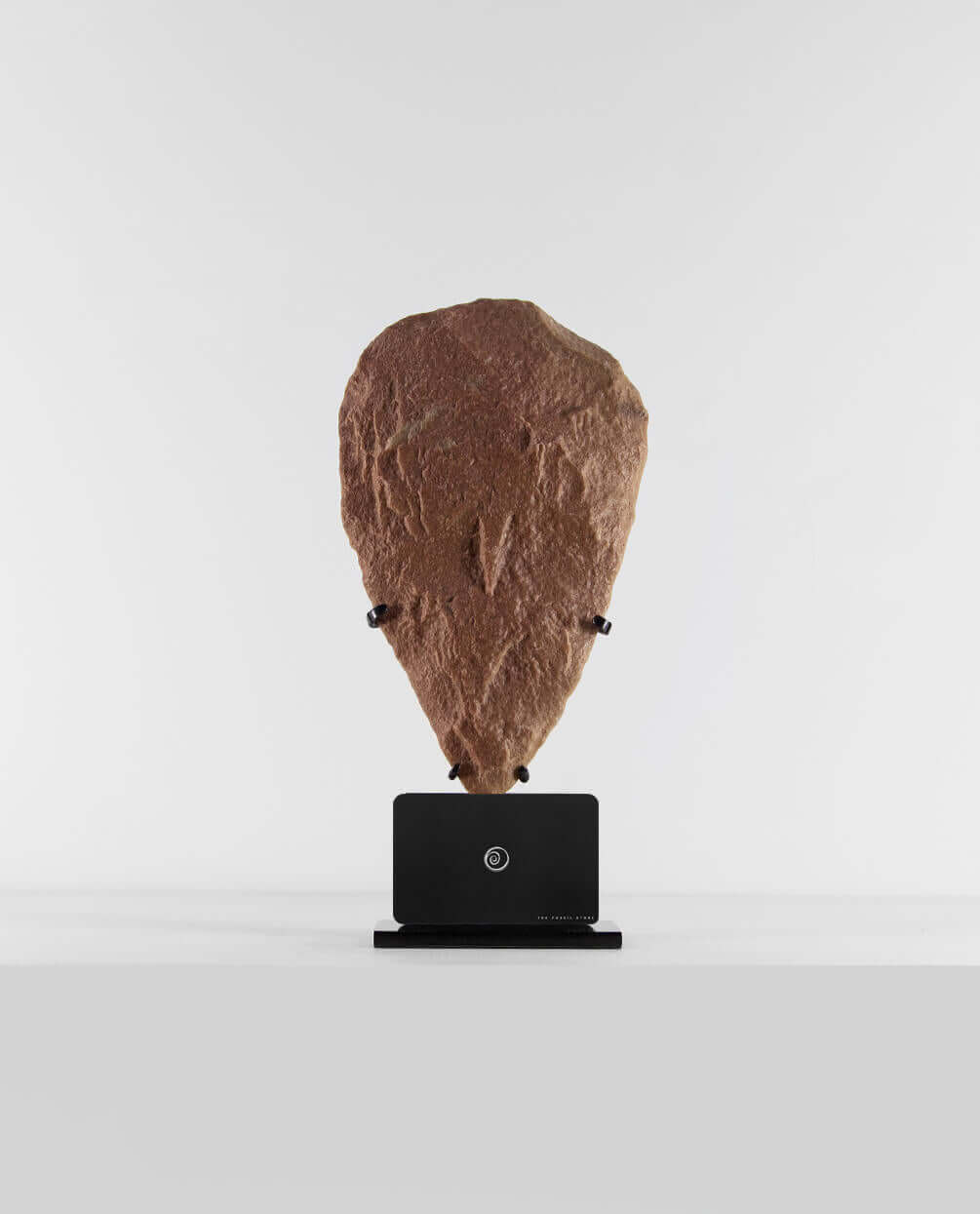 A museum-standard rare authentic Neolithic hand axe measuring 278mm on a bronze stand