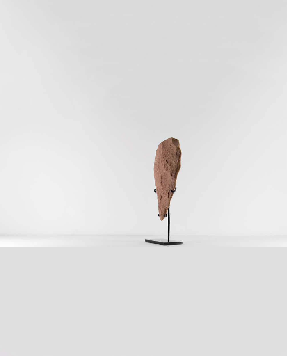 A museum-standard rare authentic Neolithic hand axe measuring 278mm on a bronze stand