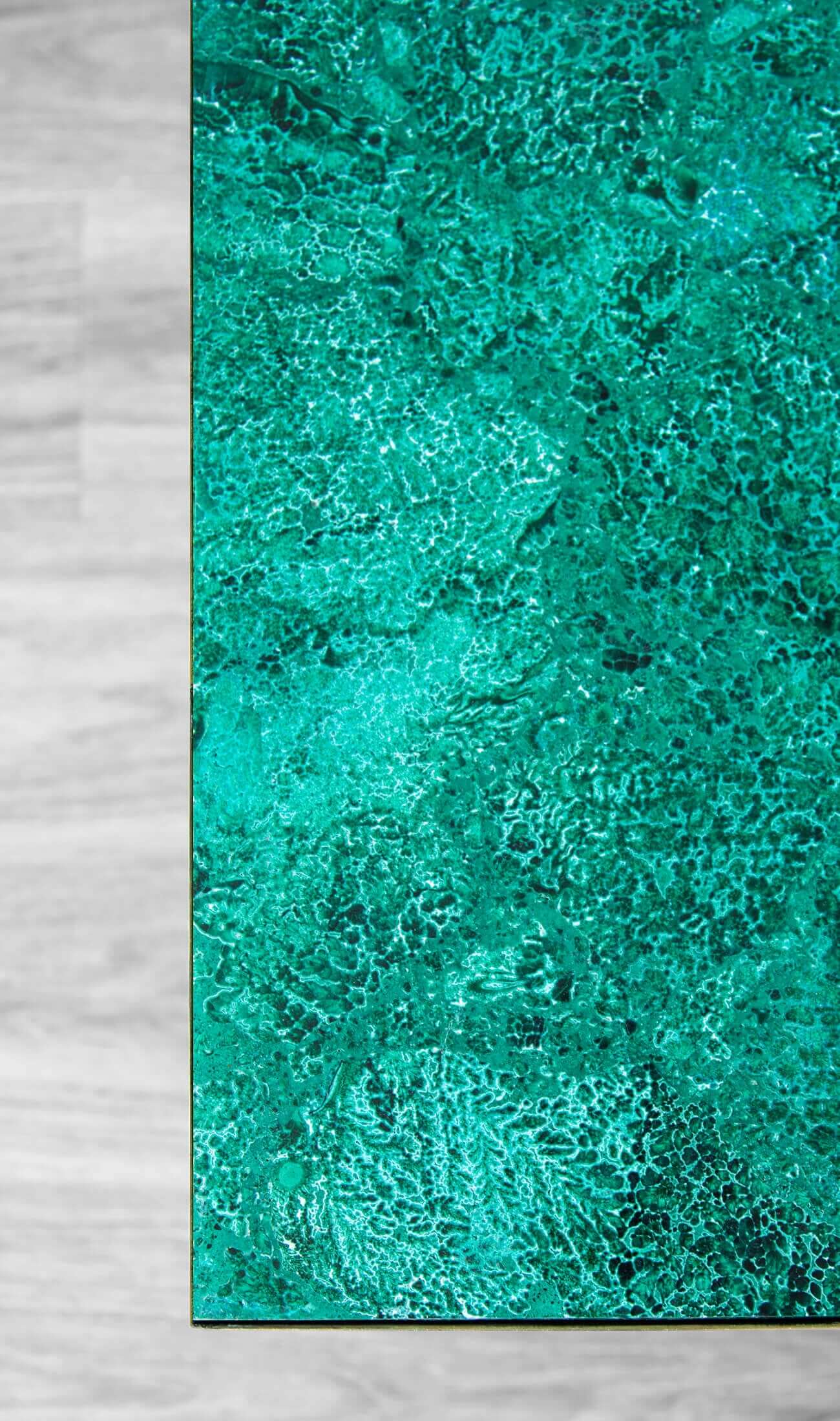 Beautifully curated Malachite tabletops presented on custom designed brass bases by THE FOSSIL STORE