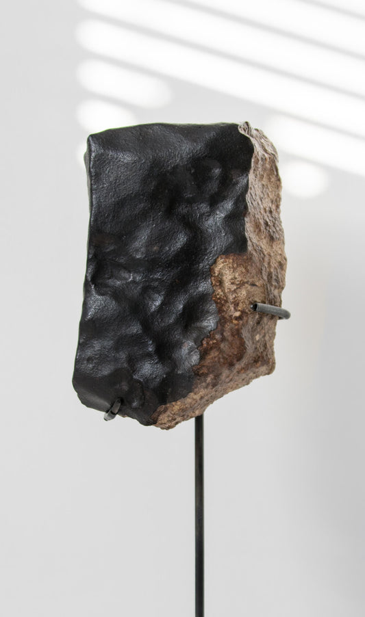 Our fallen star series NWA H5 Iron Meteorite for sale presented on a custom-designed bronze stand weighing 1448 grams