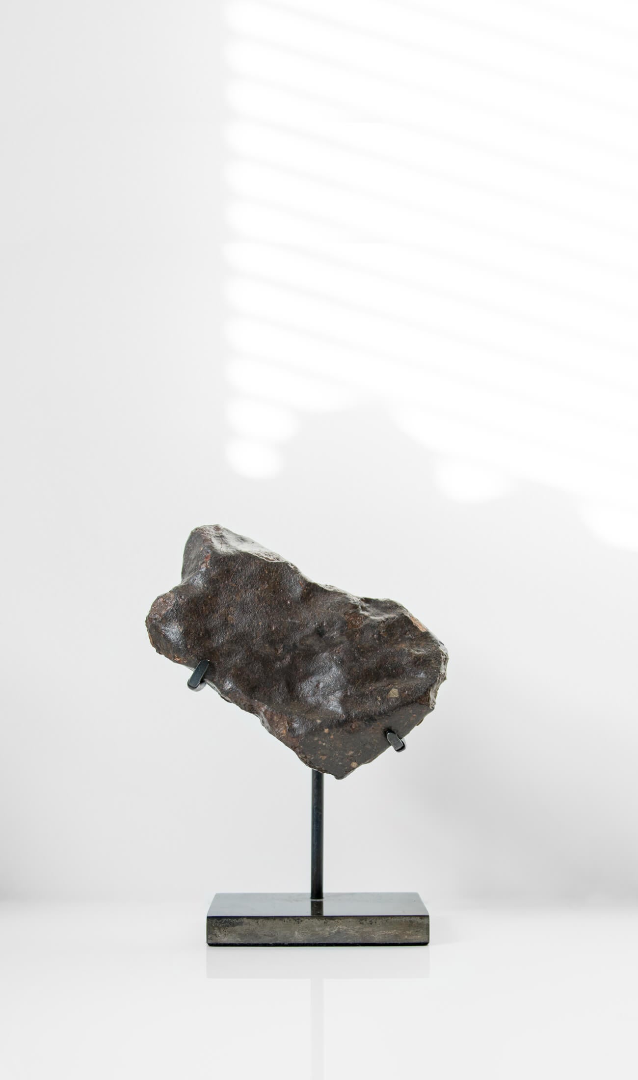 Our fallen star series NWA H5 Iron Meteorite presented on a luxury custom-designed bronze stand weighing 955 grams