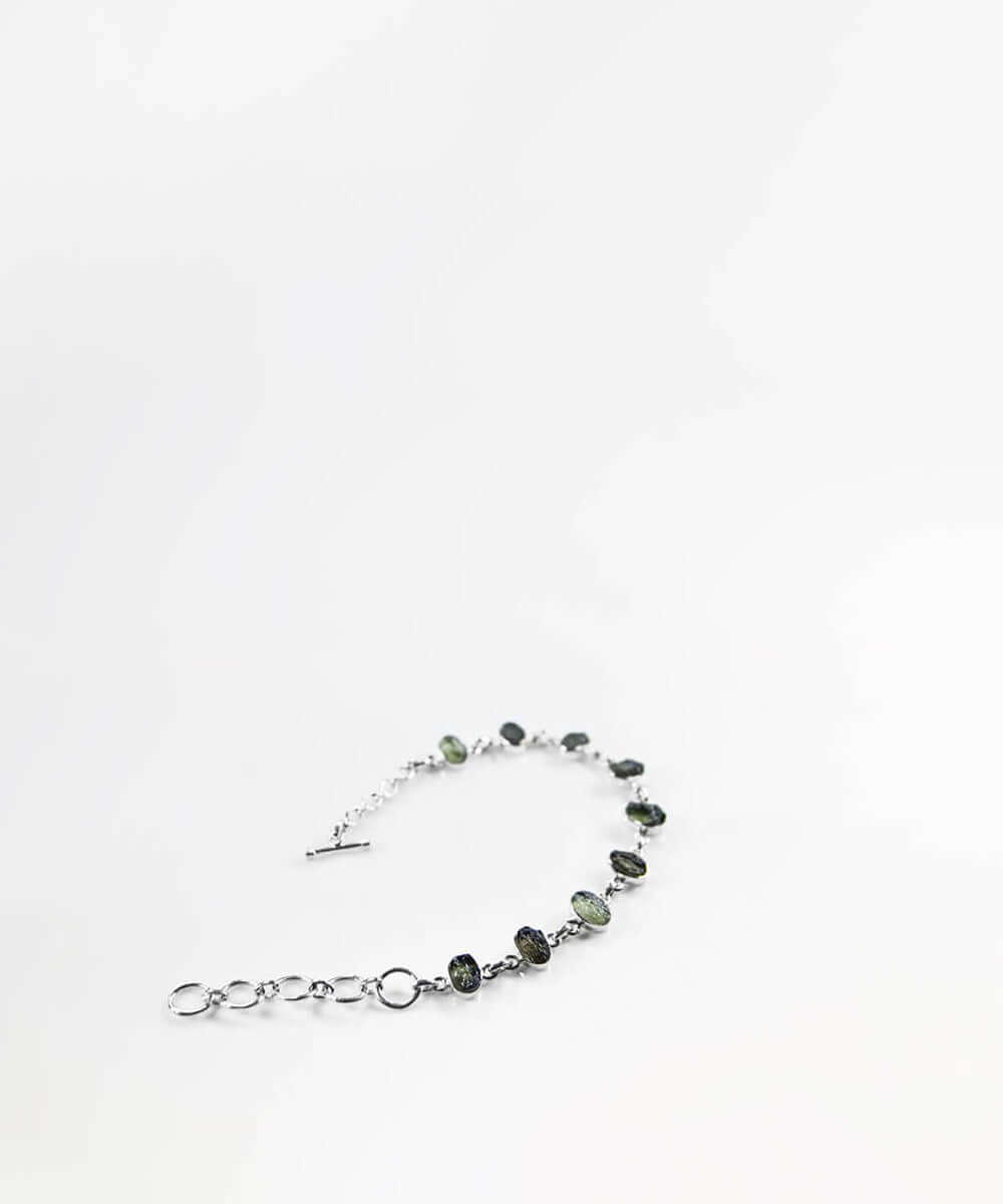 Own a beautiful green Moldavite gemstones for sale wrapped in a 925 silver bracelet now available at THE FOSSIL STORE