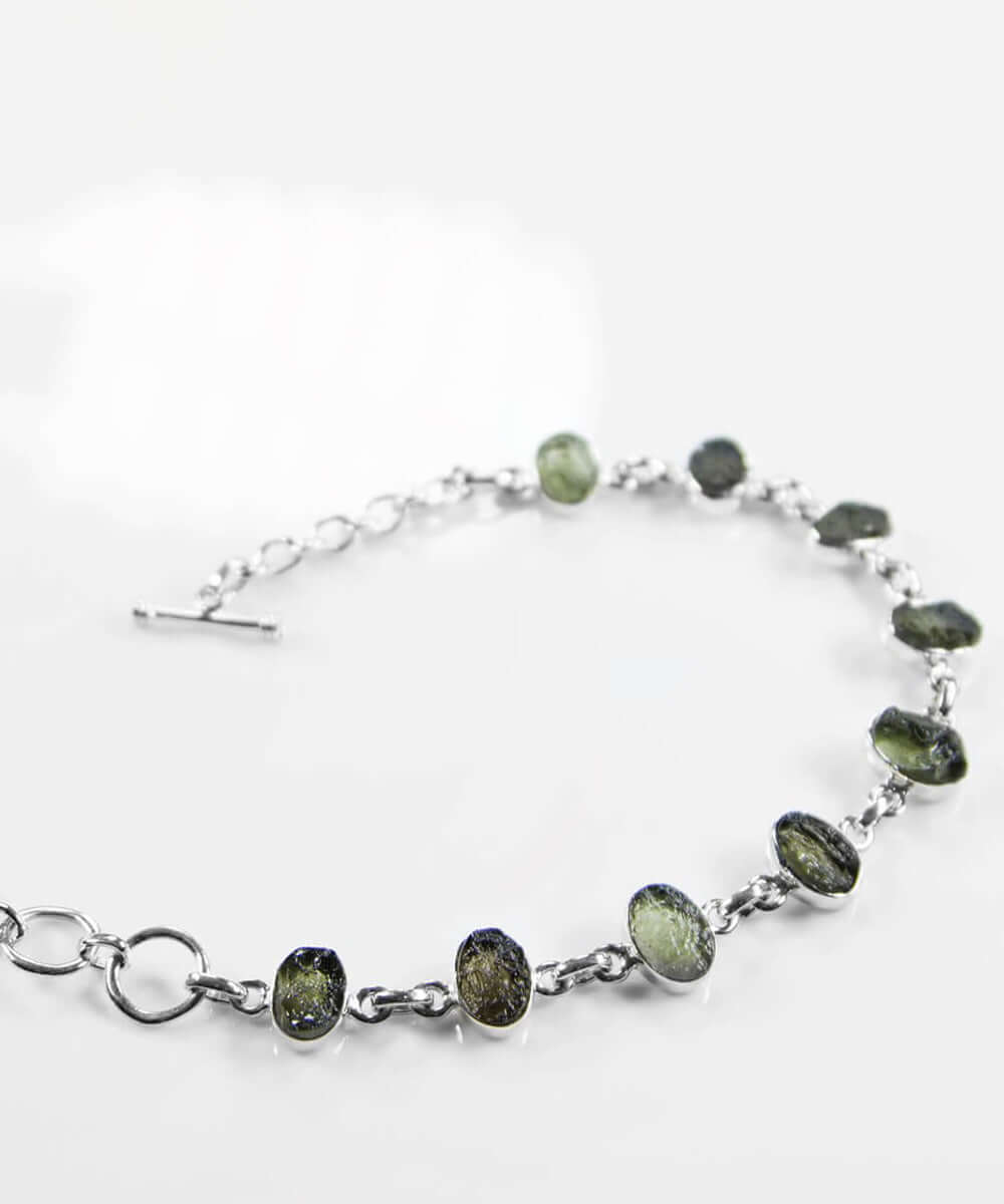 Own a beautiful green Moldavite gemstones for sale wrapped in a 925 silver bracelet now available at THE FOSSIL STORE